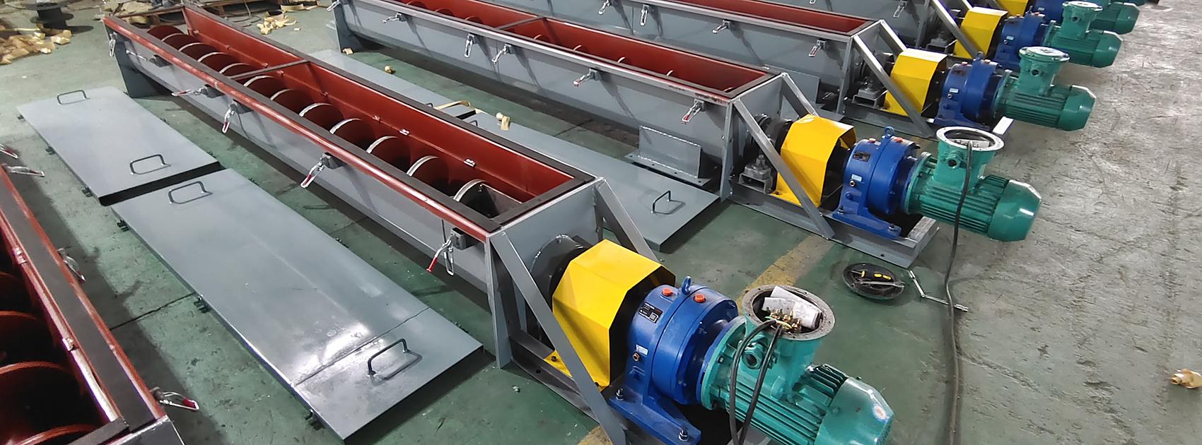 Row of U-shape screw conveyors on the factory floor